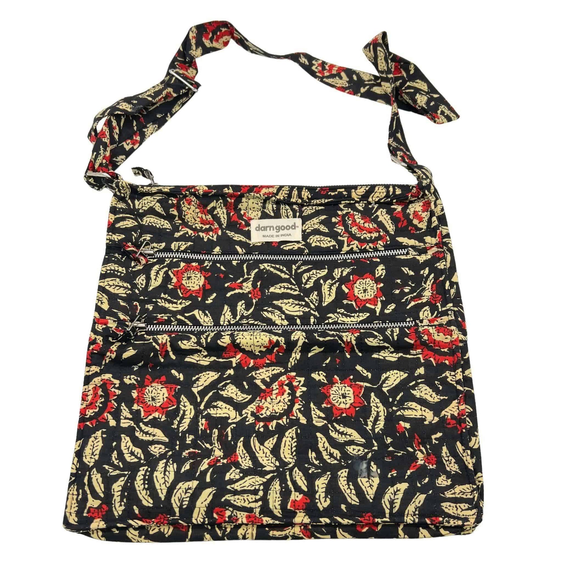 Floral patterned bag with a strap on a white background