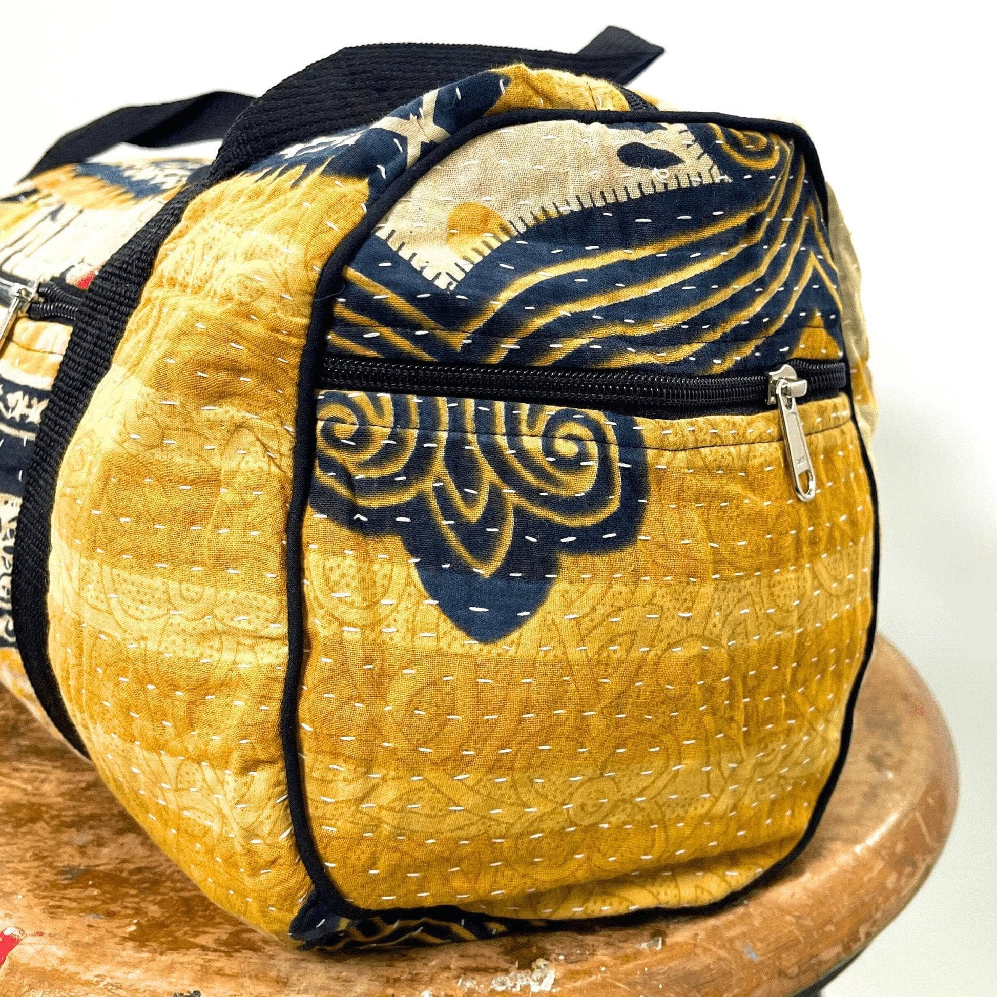 Yellow and navy patterned bag on a wooden surface