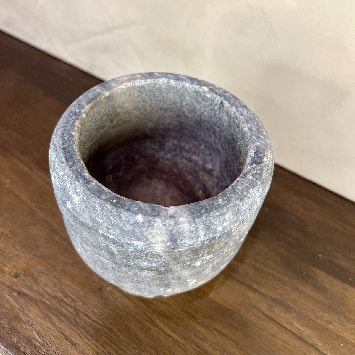Gray stone bowl on a wooden surface