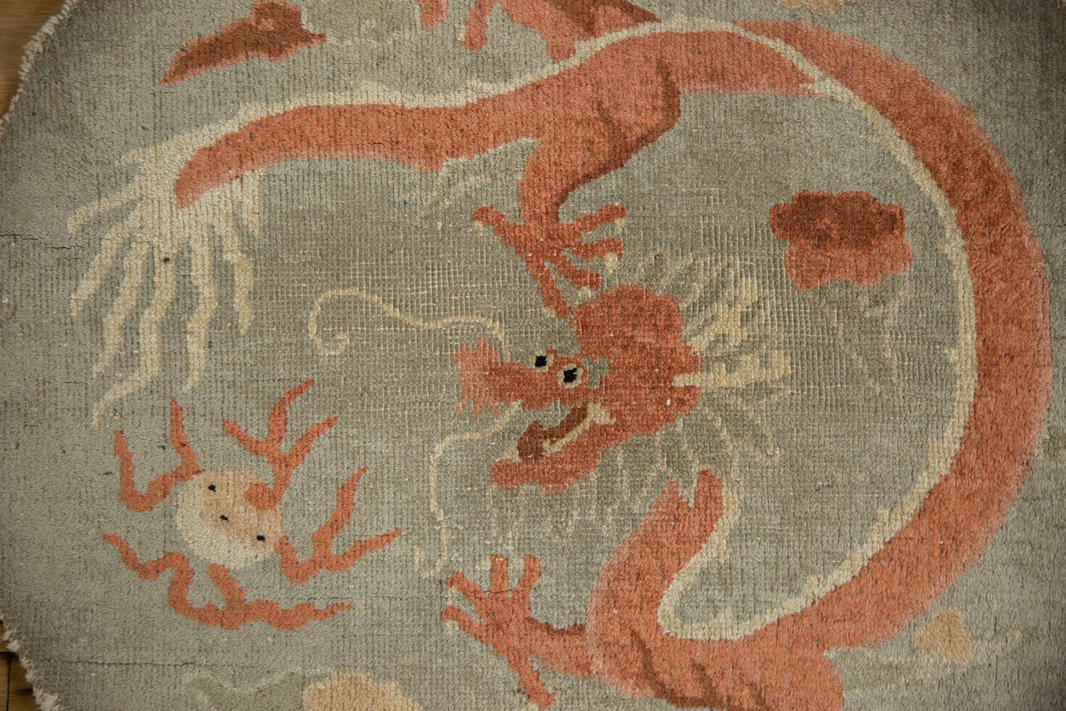 Decorative rug with a red dragon design on a beige background