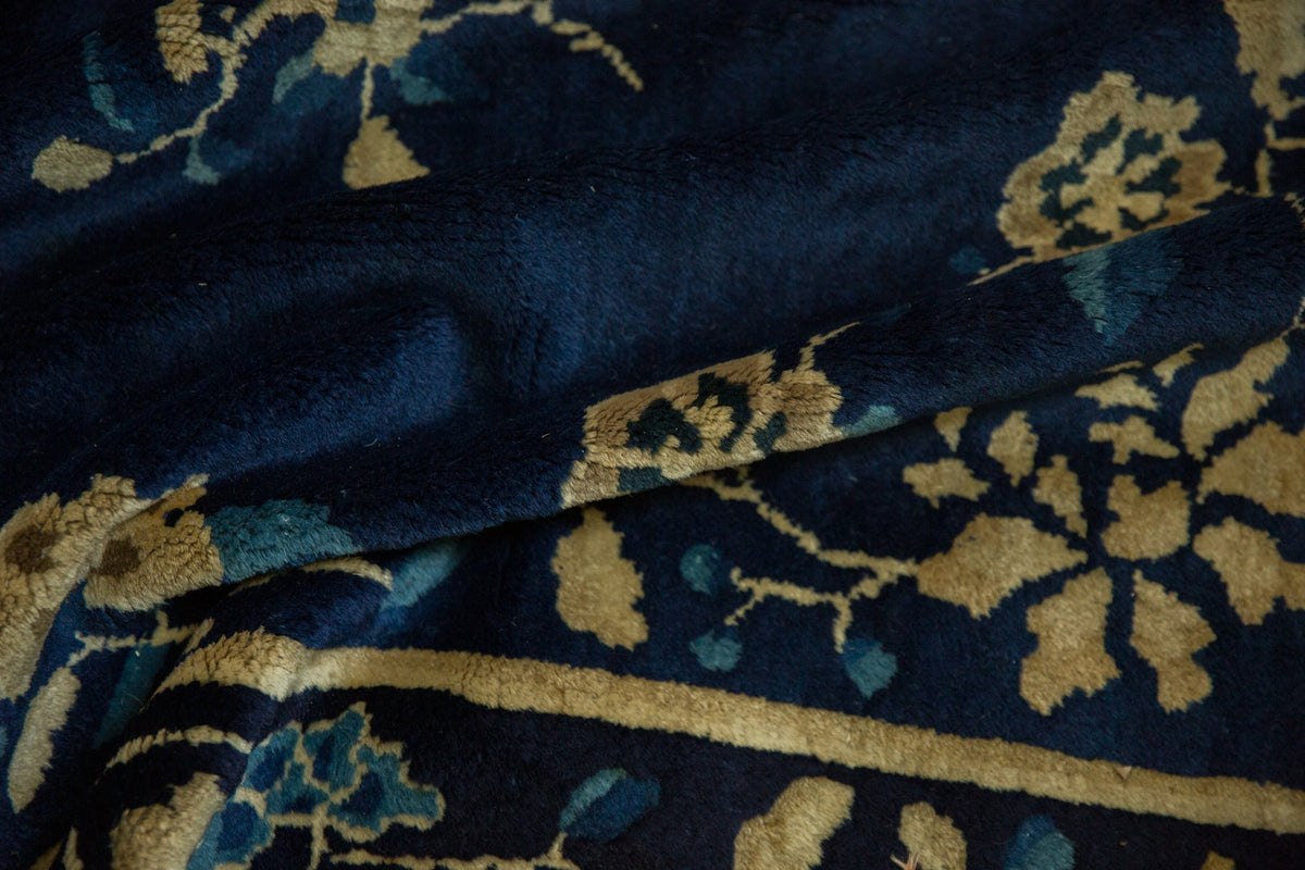 Close-up of dark blue fabric with gold floral patterns