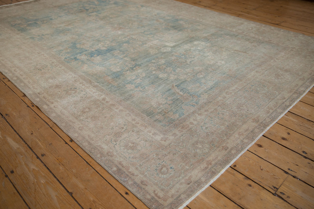 Beige and blue patterned rug on a wooden floor