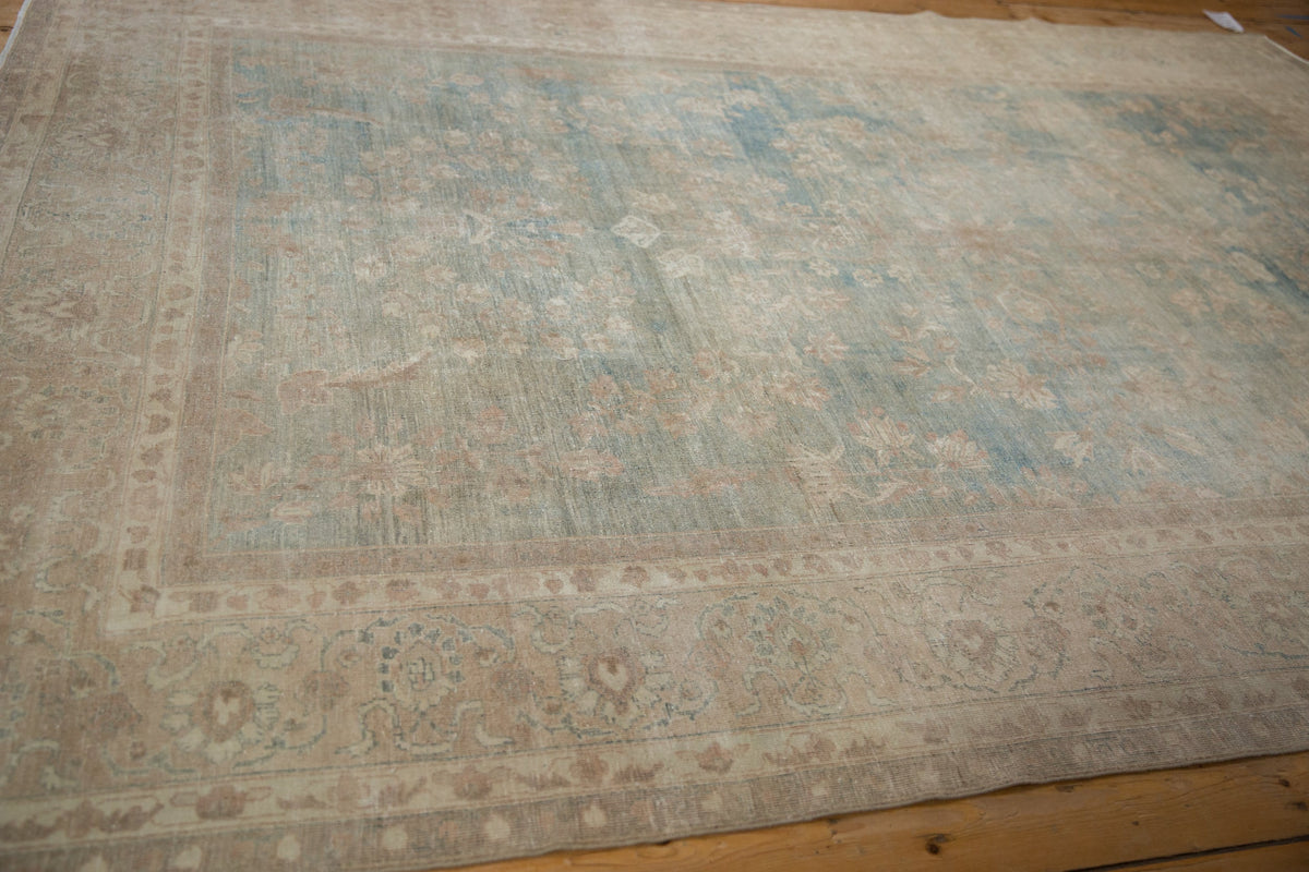 Large area rug with intricate patterns on a wooden floor