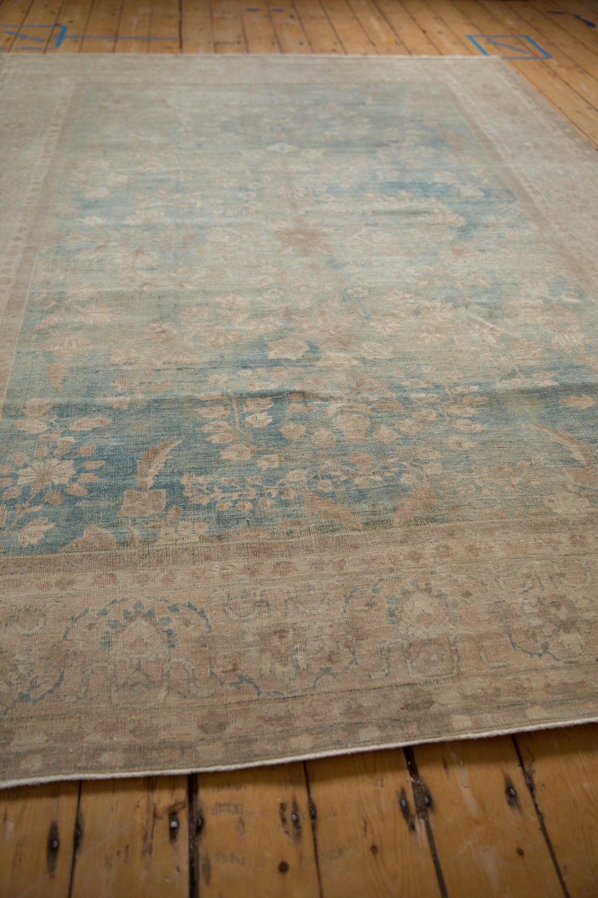 Vintage-style rug with intricate patterns on a wooden floor