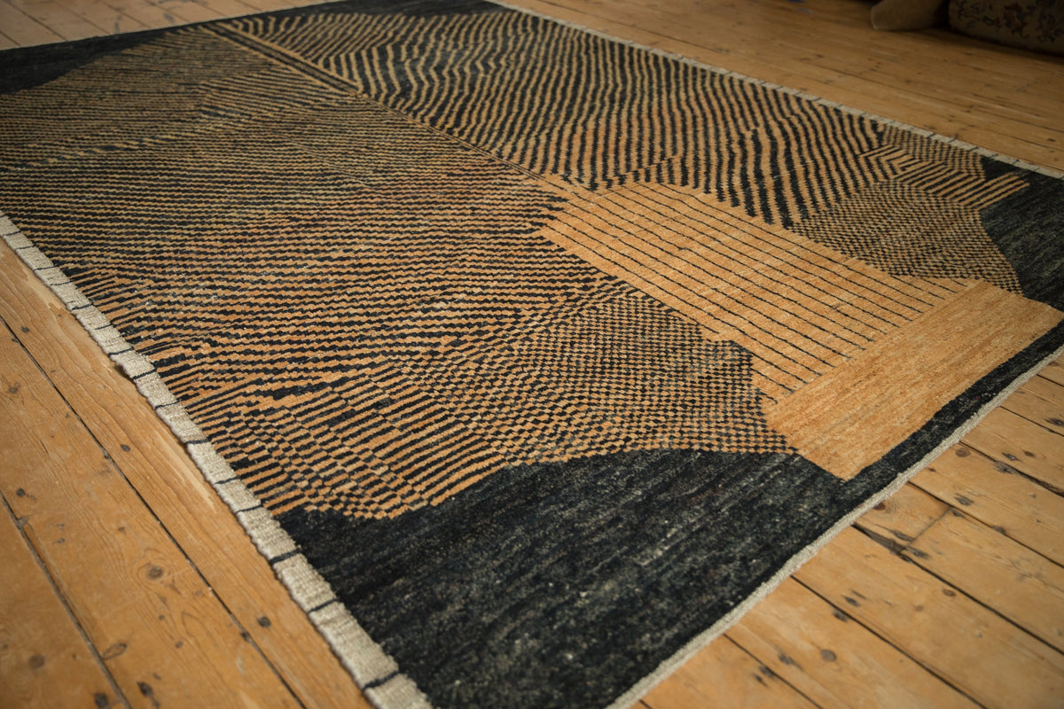 Textured area rug with geometric pattern on wooden floor