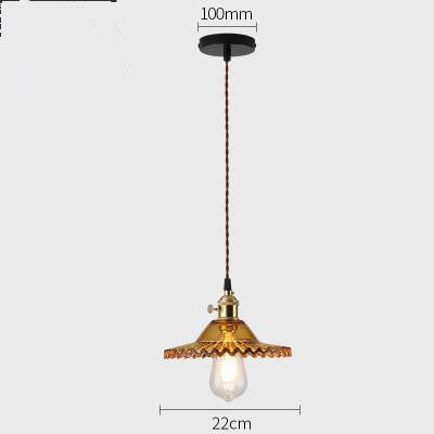 Vintage-style pendant light with decorative glass shade on a white background