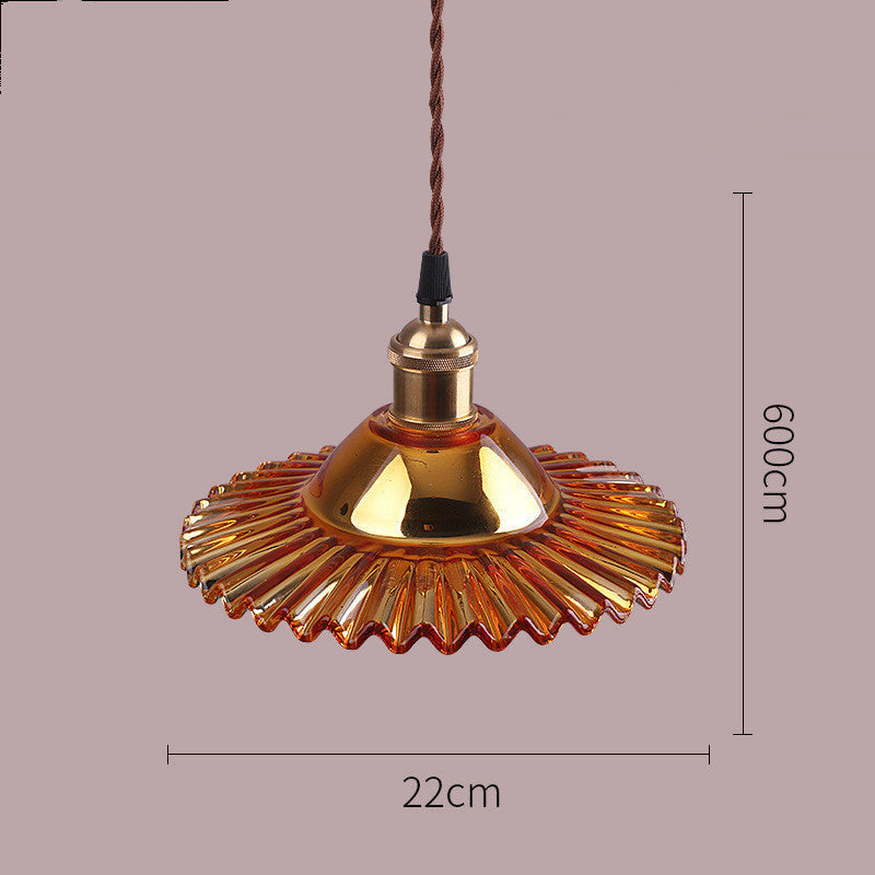 Gold pendant light with dimensions on a purple background