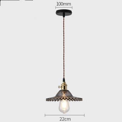 Vintage-style pendant light with decorative shade on a white background