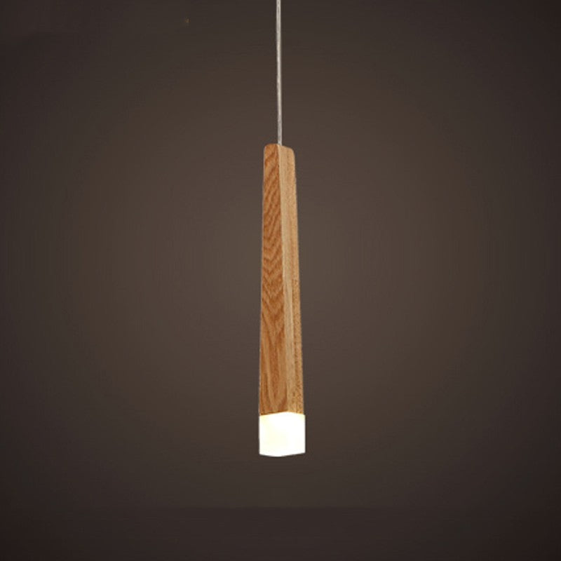 Wooden pendant light fixture on a dark background