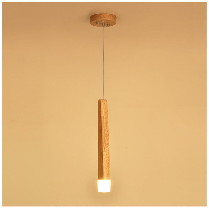 Wooden pendant light fixture on a beige background