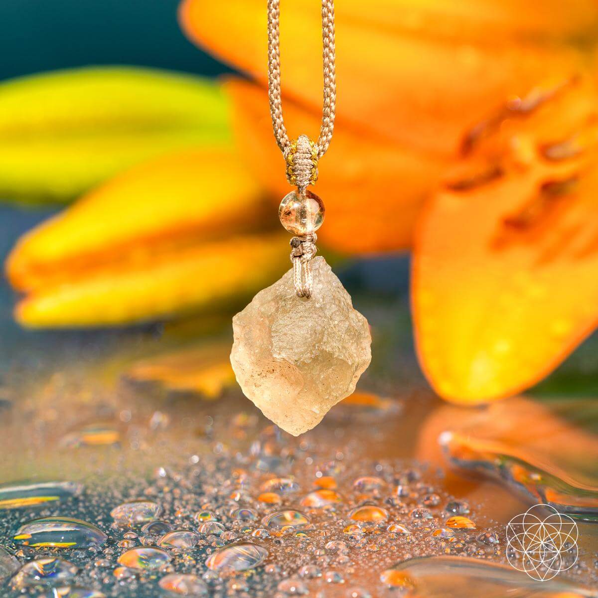 Necklace with a large, rough-cut gemstone pendant against a floral background