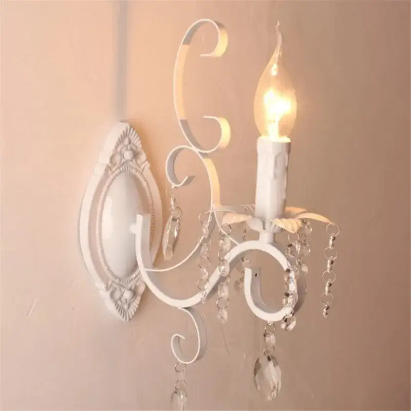 Decorative wall sconce with crystal accents on a beige wall.