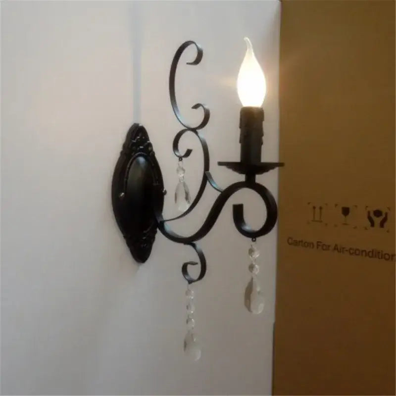 Decorative wall sconce with a light bulb on a white wall.